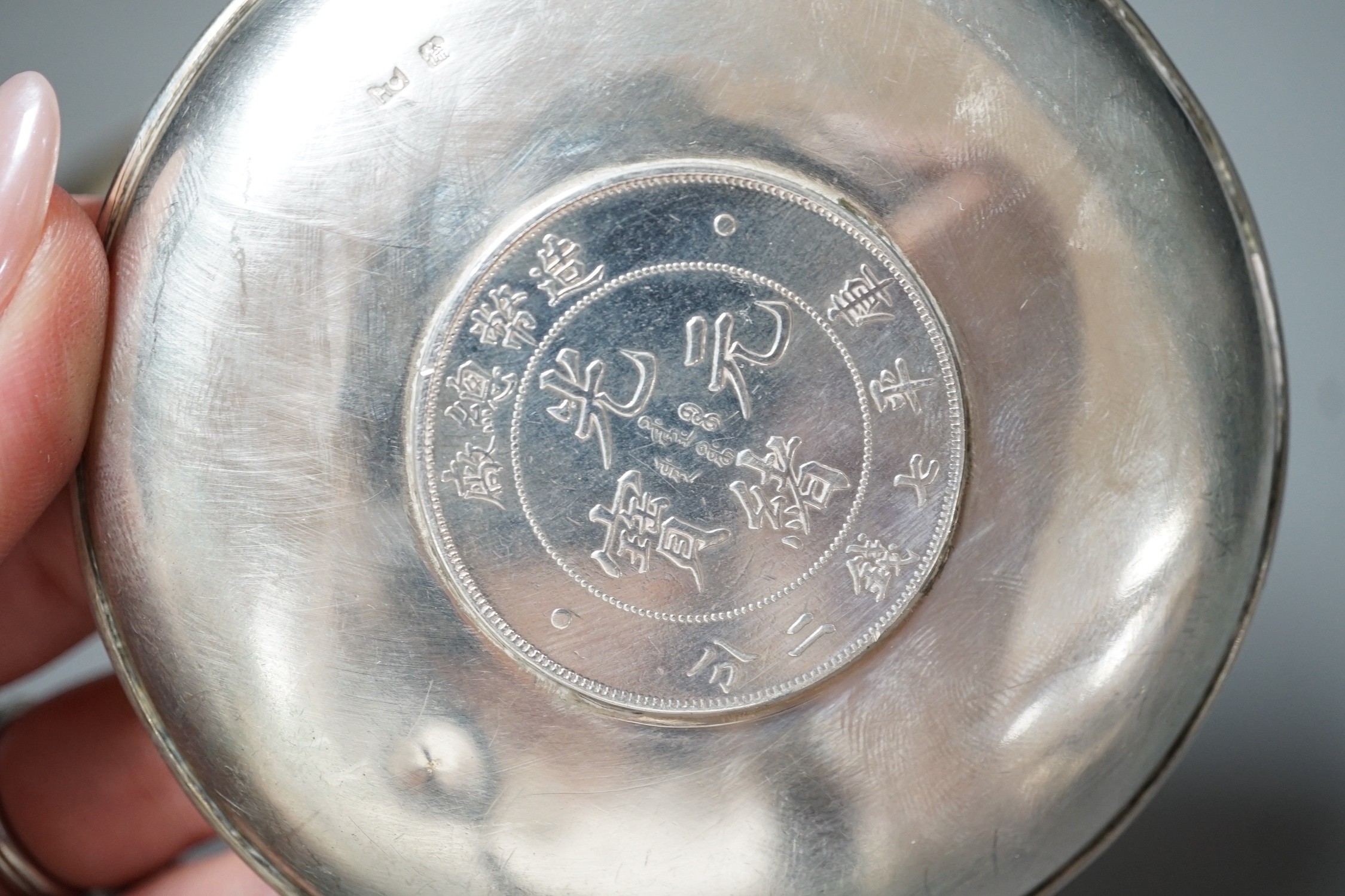 Three Chinese white metal dishes, each inset with coin, maker HC, 94mm, 196 grams gross.